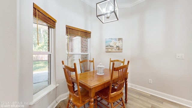 96069 Hidden Marsh Ln, Fernandina Beach, FL 32034 - dining area featuring plenty of natural light, baseboards, crown molding, light wood-type flooring, and a chandelier