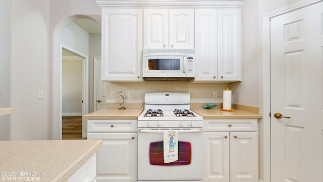 96069 Hidden Marsh Ln, Fernandina Beach, FL 32034 - kitchen with white appliances, white cabinetry, and light countertops