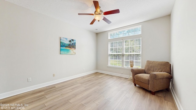 96069 Hidden Marsh Ln, Fernandina Beach, FL 32034 - sitting room with healthy amount of natural light, light wood-type flooring, baseboards, ceiling fan, and a textured ceiling