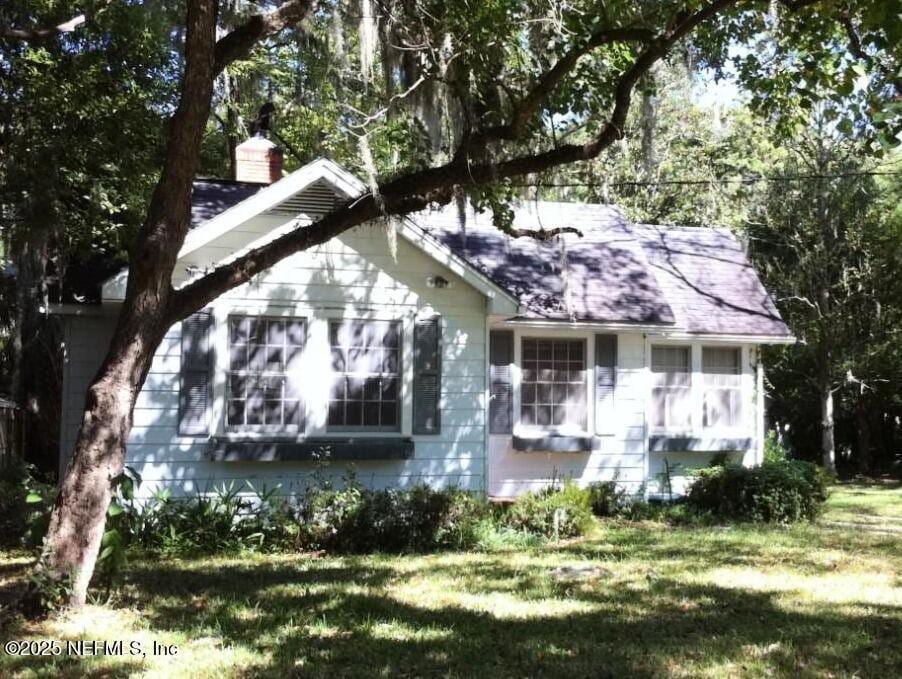 2917 Algonquin Ave, Jacksonville, FL 32210 - view of front facade featuring a front yard, a chimney, and a shingled roof