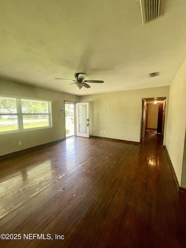 spare room with hardwood / wood-style flooring, baseboards, and a ceiling fan
