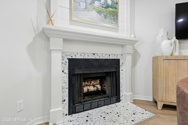 626 Ponte Vedra Blvd Unit B6, Ponte Vedra Beach, FL 32082 - detailed view of a tiled fireplace, wood finished floors, and baseboards