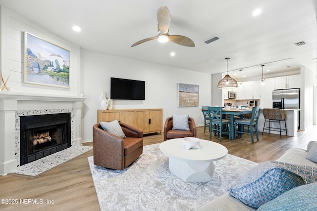 626 Ponte Vedra Blvd Unit B6, Ponte Vedra Beach, FL 32082 - living area featuring light wood finished floors, ceiling fan, recessed lighting, a tile fireplace, and baseboards