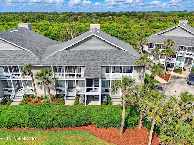 626 Ponte Vedra Blvd Unit B6, Ponte Vedra Beach, FL 32082 - rear view of house with roof with shingles and a view of trees