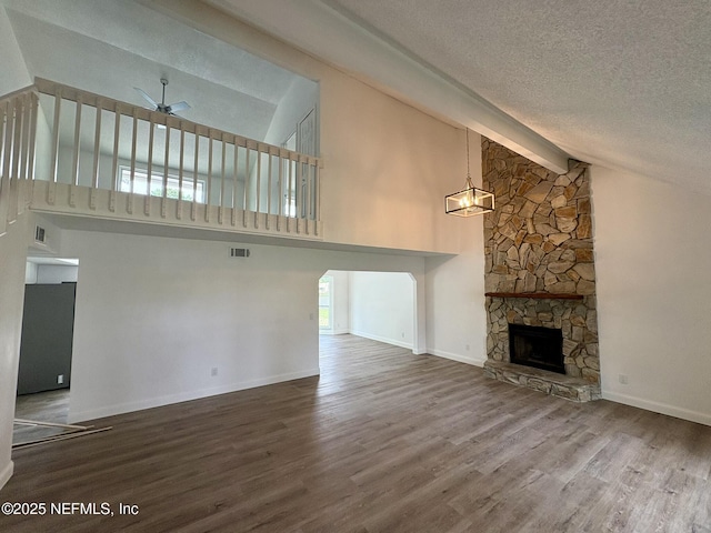 946 Cedar Ridge Ct, Orange Park, FL 32065 - unfurnished living room with a ceiling fan, wood finished floors, a fireplace, beam ceiling, and high vaulted ceiling