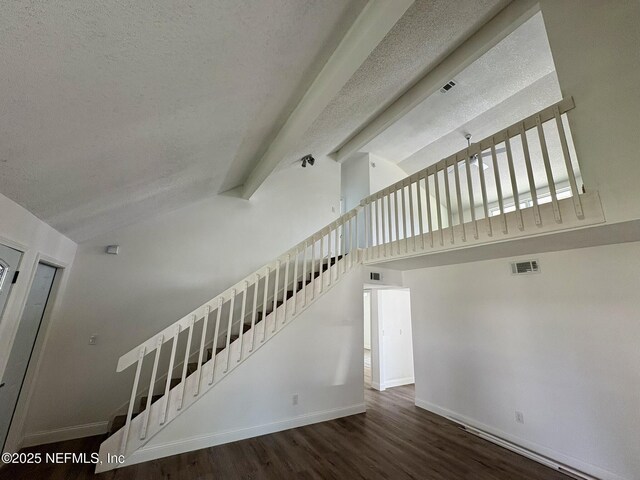946 Cedar Ridge Ct, Orange Park, FL 32065 - stairs featuring vaulted ceiling, a textured ceiling, wood finished floors, and baseboards