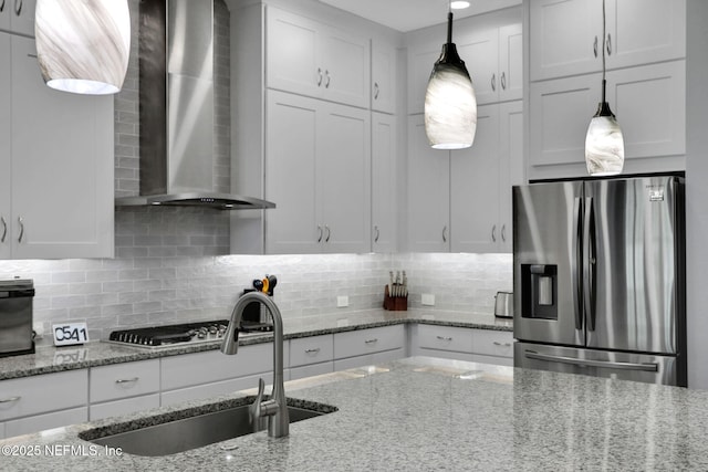 195 Manor Ln, Saint Johns, FL 32259 - kitchen with appliances with stainless steel finishes, wall chimney range hood, a sink, white cabinetry, and backsplash