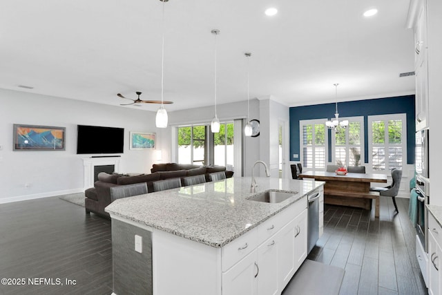195 Manor Ln, Saint Johns, FL 32259 - kitchen with a sink, appliances with stainless steel finishes, a kitchen island with sink, dark wood-style floors, and white cabinets