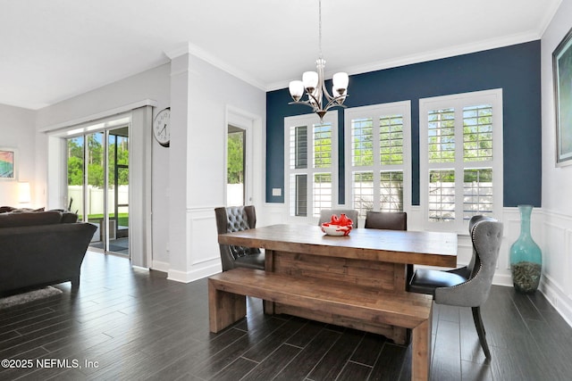 195 Manor Ln, Saint Johns, FL 32259 - dining area featuring a chandelier, wainscoting, dark wood-style flooring, crown molding, and a decorative wall