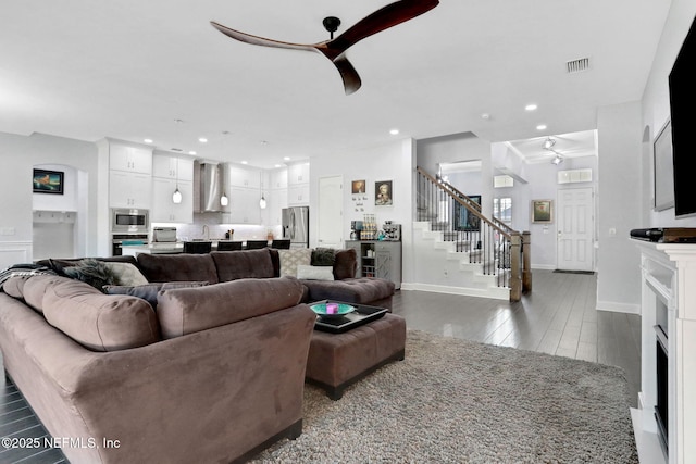 195 Manor Ln, Saint Johns, FL 32259 - living room featuring ceiling fan, stairs, dark wood-style flooring, baseboards, and a fireplace