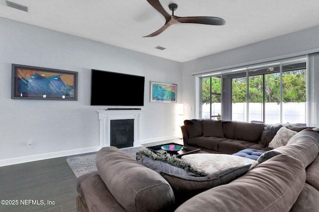 195 Manor Ln, Saint Johns, FL 32259 - living room with baseboards, a ceiling fan, wood finished floors, and a glass covered fireplace