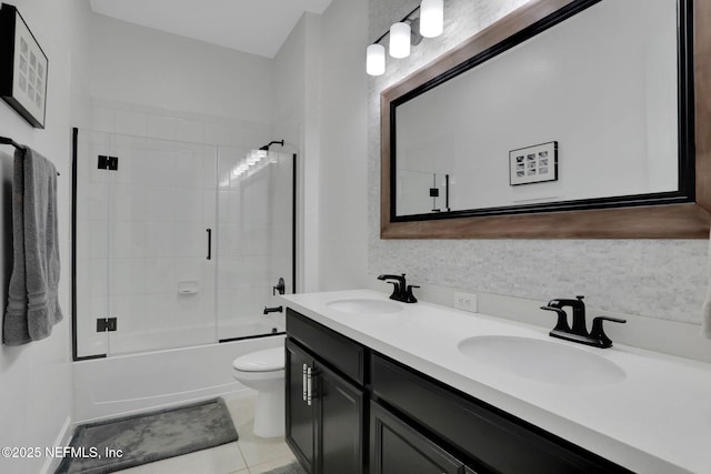 195 Manor Ln, Saint Johns, FL 32259 - bathroom featuring double vanity, combined bath / shower with glass door, toilet, and tile patterned floors