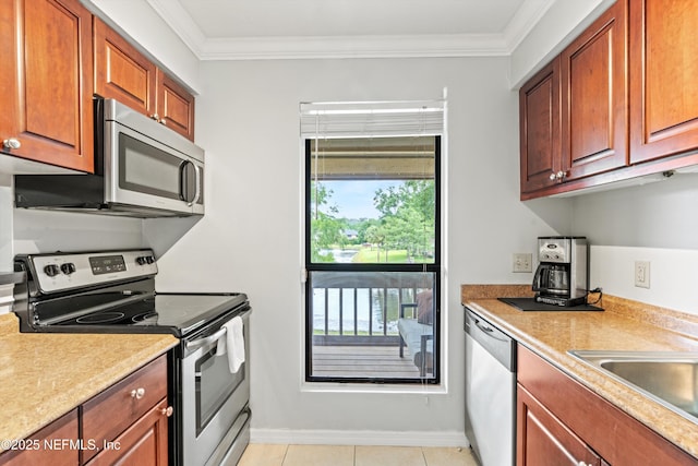 10200 Belle Rive Blvd Unit 136, Jacksonville, FL 32256 - kitchen featuring appliances with stainless steel finishes, crown molding, light countertops, a sink, and brown cabinetry