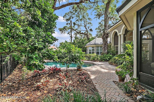view of pool with fence and a patio area