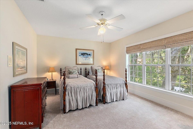 bedroom featuring carpet, baseboards, and a ceiling fan