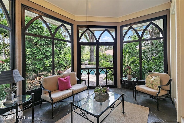 sunroom featuring stone tile flooring
