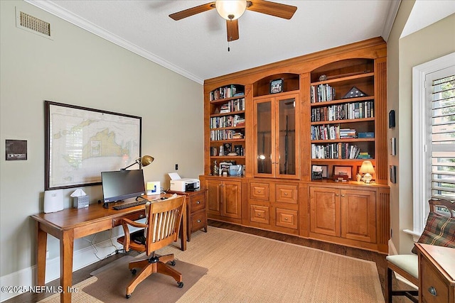 home office featuring a ceiling fan, crown molding, and baseboards