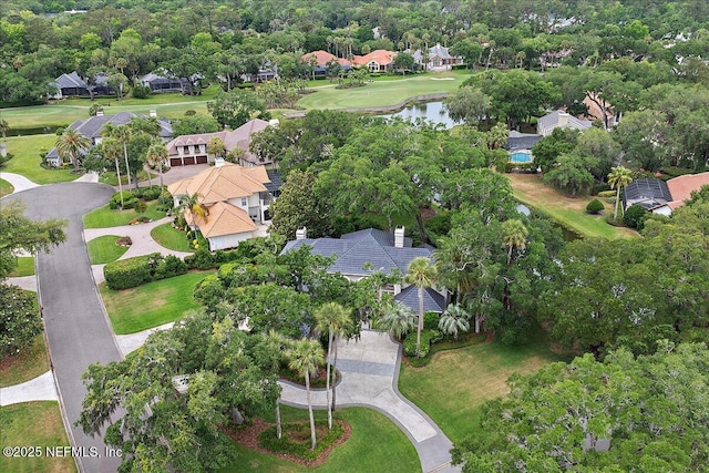 aerial view of property and surrounding area with nearby suburban area and a large body of water