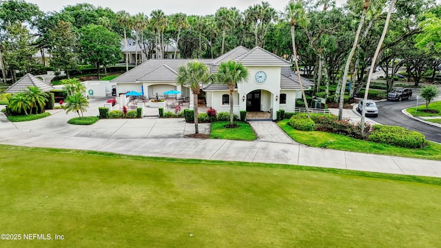 100 Carriage Ct, Ponte Vedra Beach, FL 32082 - view of front of home featuring stucco siding, a tiled roof, and driveway