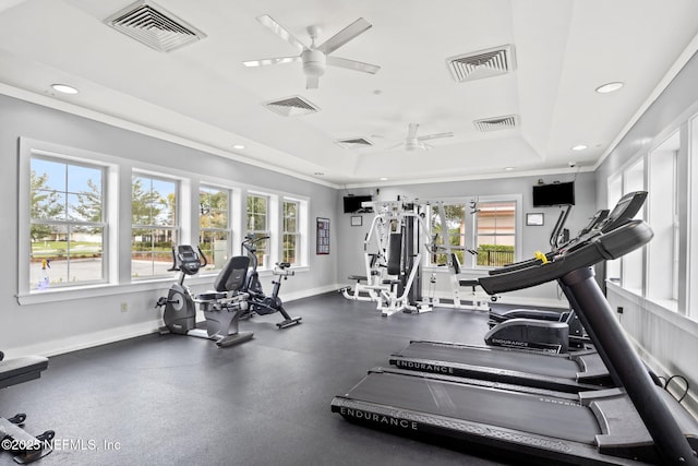 exercise room featuring ceiling fan, a tray ceiling, recessed lighting, baseboards, and ornamental molding