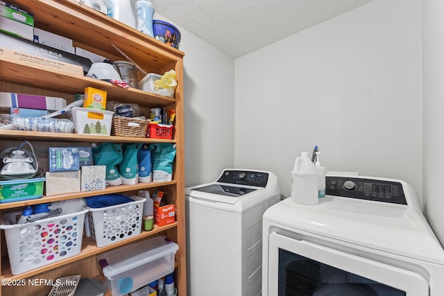 clothes washing area with independent washer and dryer and a textured ceiling