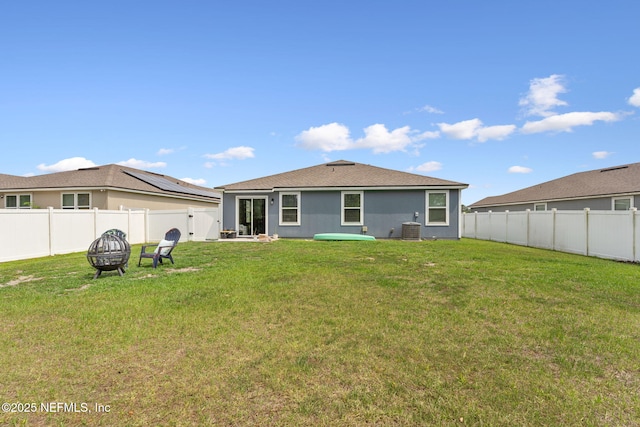 back of house featuring a fire pit and central AC