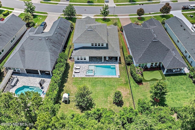 aerial perspective of suburban area featuring a pool area