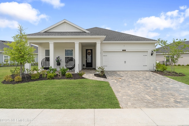 321 Varner Way, Saint Augustine, FL 32092 - view of front of home with covered porch, decorative driveway, a garage, a front lawn, and roof with shingles