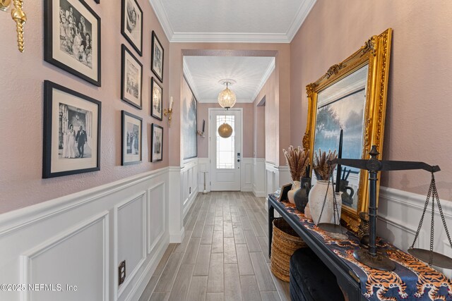 321 Varner Way, Saint Augustine, FL 32092 - doorway to outside featuring ornamental molding, wainscoting, wood finished floors, and a decorative wall