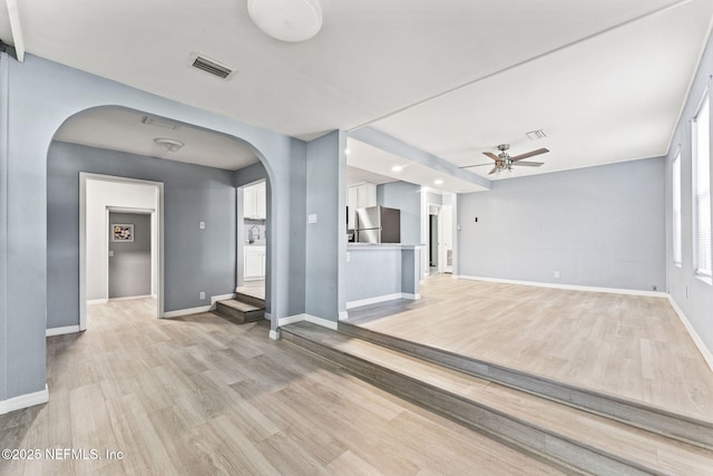 2617 Lake Shore Blvd, Jacksonville, FL 32210 - unfurnished living room with arched walkways, ceiling fan, light wood-type flooring, baseboards, and recessed lighting