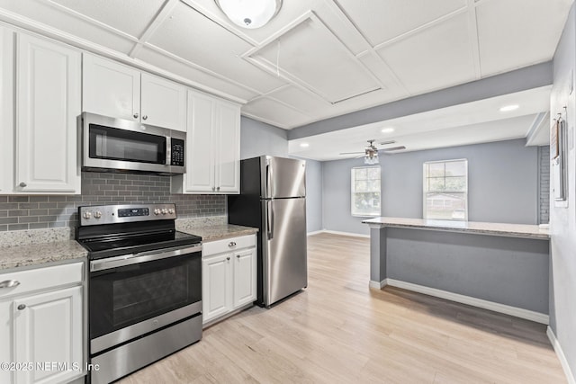 2617 Lake Shore Blvd, Jacksonville, FL 32210 - kitchen featuring appliances with stainless steel finishes, backsplash, baseboards, white cabinetry, and recessed lighting