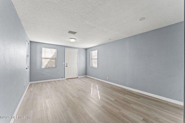 2617 Lake Shore Blvd, Jacksonville, FL 32210 - empty room featuring wood finished floors, a textured ceiling, and baseboards