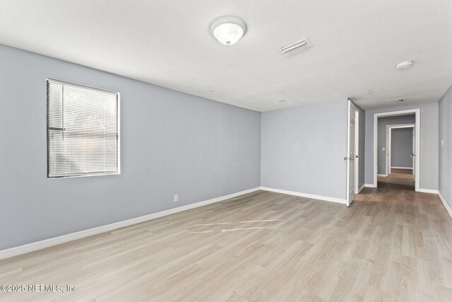 2617 Lake Shore Blvd, Jacksonville, FL 32210 - empty room featuring wood finished floors, baseboards, and a textured ceiling