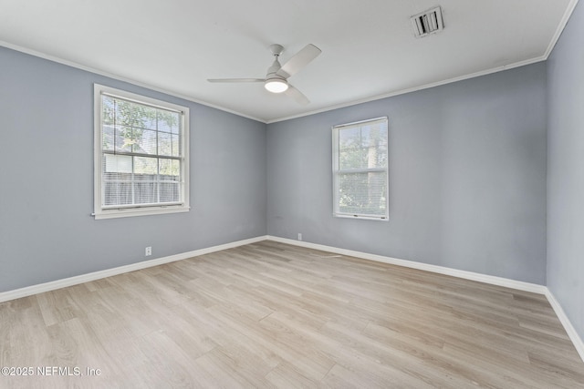 2617 Lake Shore Blvd, Jacksonville, FL 32210 - spare room with crown molding, plenty of natural light, a ceiling fan, light wood-type flooring, and baseboards