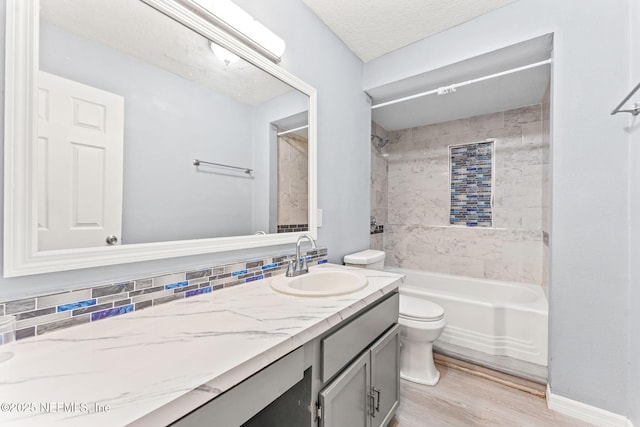 2617 Lake Shore Blvd, Jacksonville, FL 32210 - full bath featuring toilet, wood finished floors, shower / washtub combination, vanity, and decorative backsplash