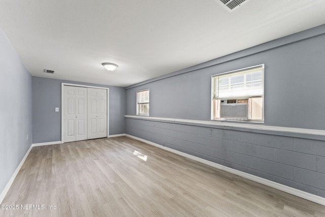 2617 Lake Shore Blvd, Jacksonville, FL 32210 - unfurnished bedroom featuring wood finished floors, a closet, baseboards, and cooling unit