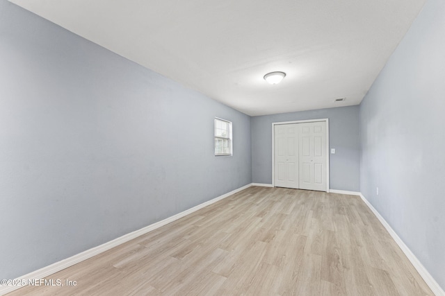 2617 Lake Shore Blvd, Jacksonville, FL 32210 - unfurnished bedroom featuring light wood finished floors, baseboards, and a closet