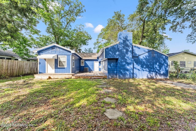 2617 Lake Shore Blvd, Jacksonville, FL 32210 - view of front of house featuring a chimney, a deck, and central AC unit
