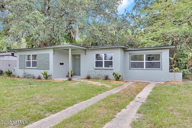 5530 Sharon Ter, Jacksonville, FL 32207 - view of front of house featuring concrete block siding and a front lawn