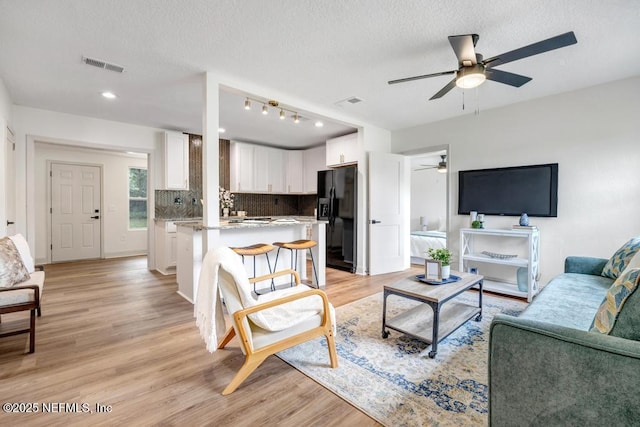 5530 Sharon Ter, Jacksonville, FL 32207 - living area featuring a ceiling fan, light wood-type flooring, a textured ceiling, and recessed lighting