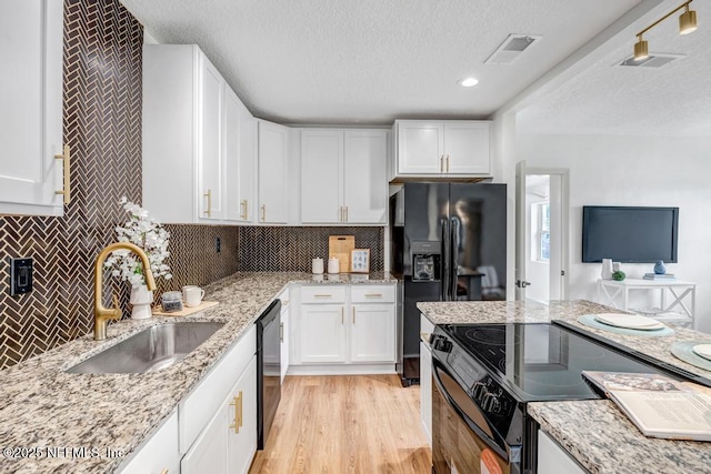 5530 Sharon Ter, Jacksonville, FL 32207 - kitchen featuring a sink, black appliances, a textured ceiling, white cabinetry, and recessed lighting