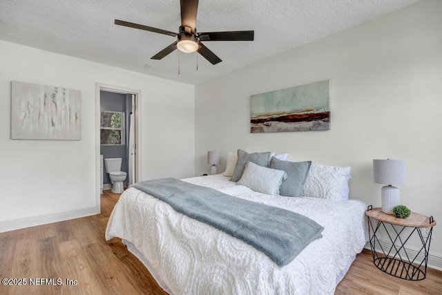 5530 Sharon Ter, Jacksonville, FL 32207 - bedroom with wood finished floors, baseboards, a textured ceiling, connected bathroom, and a ceiling fan