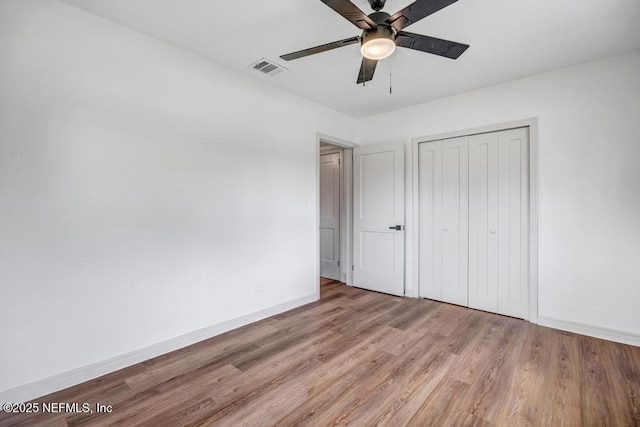 5530 Sharon Ter, Jacksonville, FL 32207 - unfurnished bedroom featuring baseboards, wood finished floors, a closet, and a ceiling fan