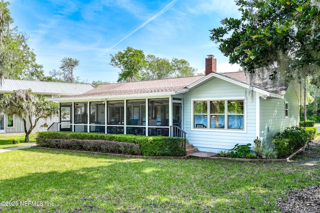 130 Woodbury Trl, Satsuma, FL 32189 - rear view of house featuring a sunroom, a lawn, a chimney, and a ceiling fan