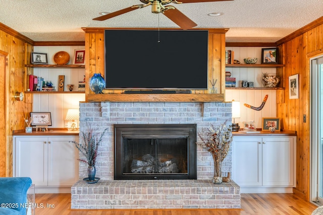 130 Woodbury Trl, Satsuma, FL 32189 - detailed view of a textured ceiling, wood walls, crown molding, ceiling fan, and wood finished floors