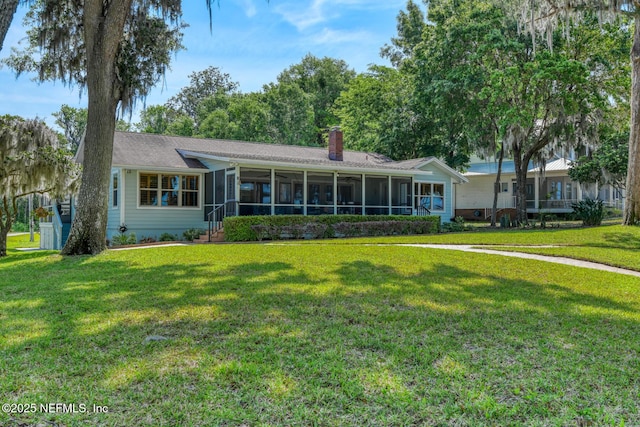 130 Woodbury Trl, Satsuma, FL 32189 - view of front of home with a sunroom, a front yard, and a chimney