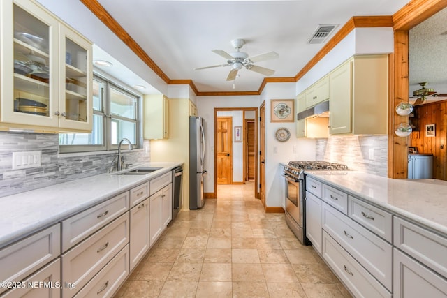 130 Woodbury Trl, Satsuma, FL 32189 - kitchen with stainless steel appliances, a sink, a ceiling fan, backsplash, and ornamental molding