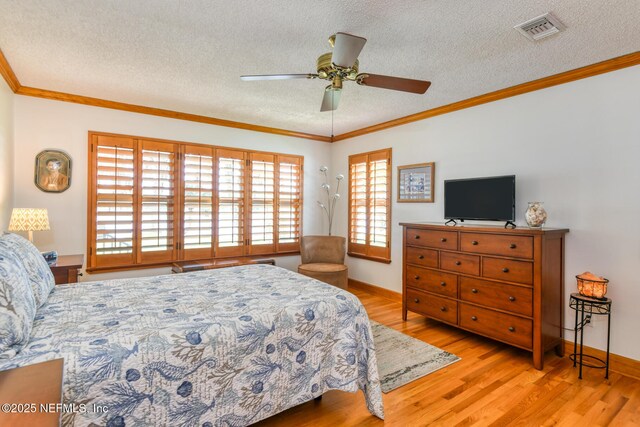 130 Woodbury Trl, Satsuma, FL 32189 - bedroom with wood finished floors, a textured ceiling, ornamental molding, a ceiling fan, and baseboards