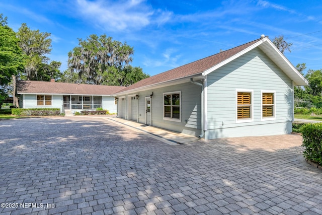 130 Woodbury Trl, Satsuma, FL 32189 - view of front of property with an attached garage, decorative driveway, and a sunroom