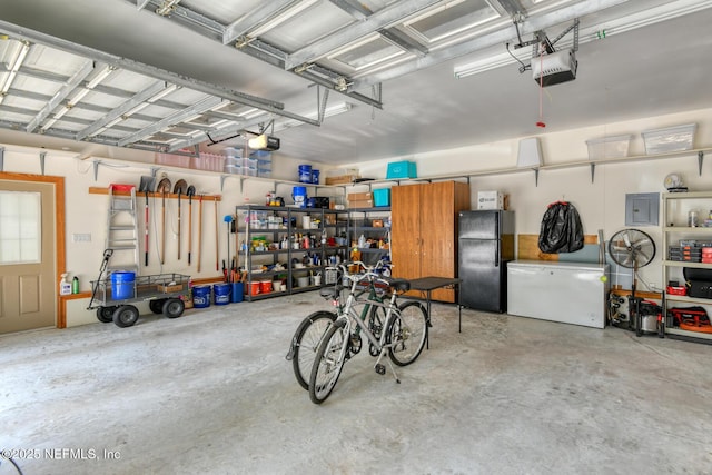 130 Woodbury Trl, Satsuma, FL 32189 - garage with freestanding refrigerator, a garage door opener, fridge, and electric panel